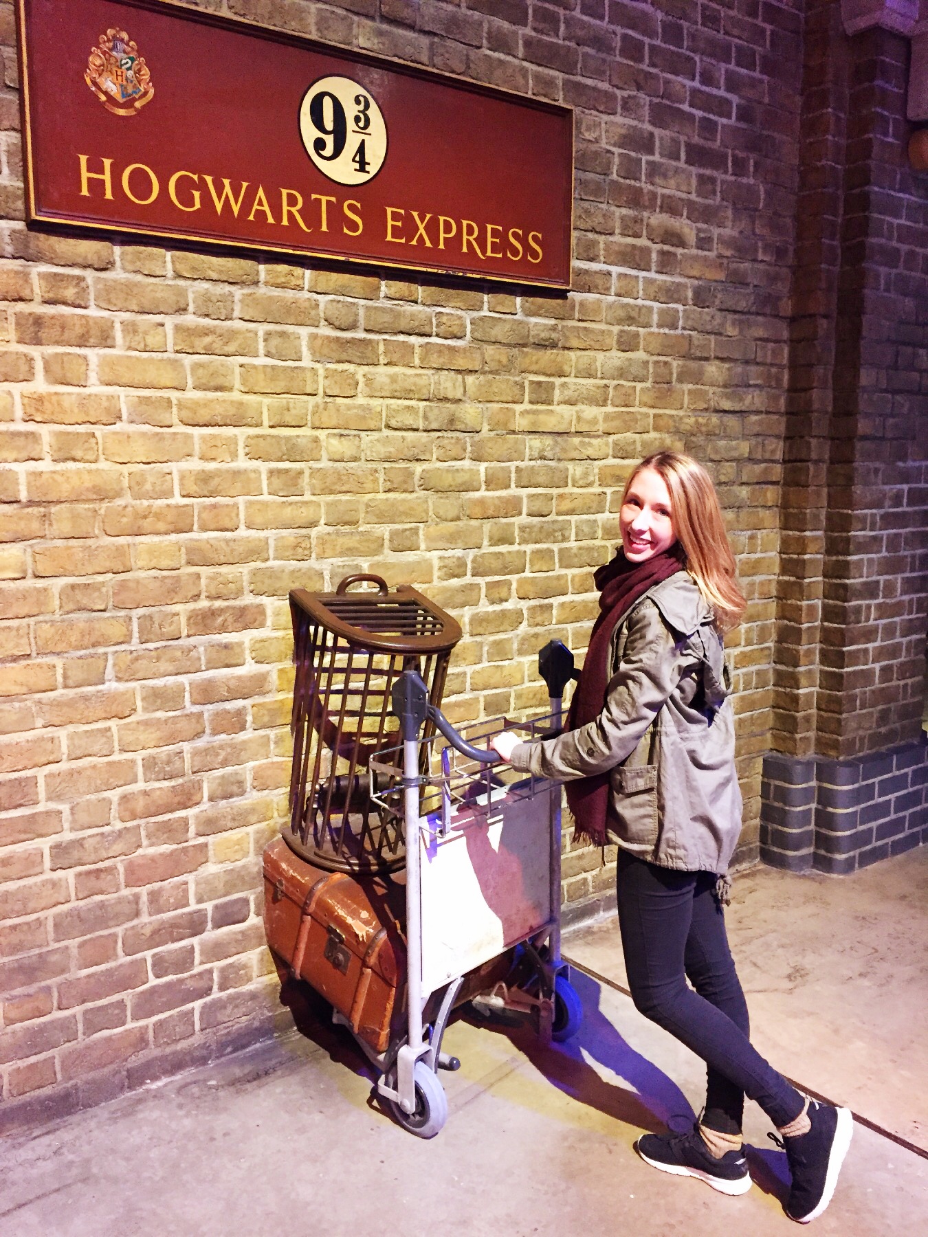 Amanda walking through the wall of Platform 9 3/4 to get to the Hogwarts Express