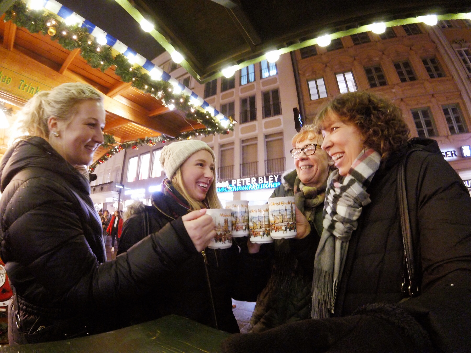 Amanda with her friend, Liza, Mom & Mother-in-law toasting their glühwein mugs. 